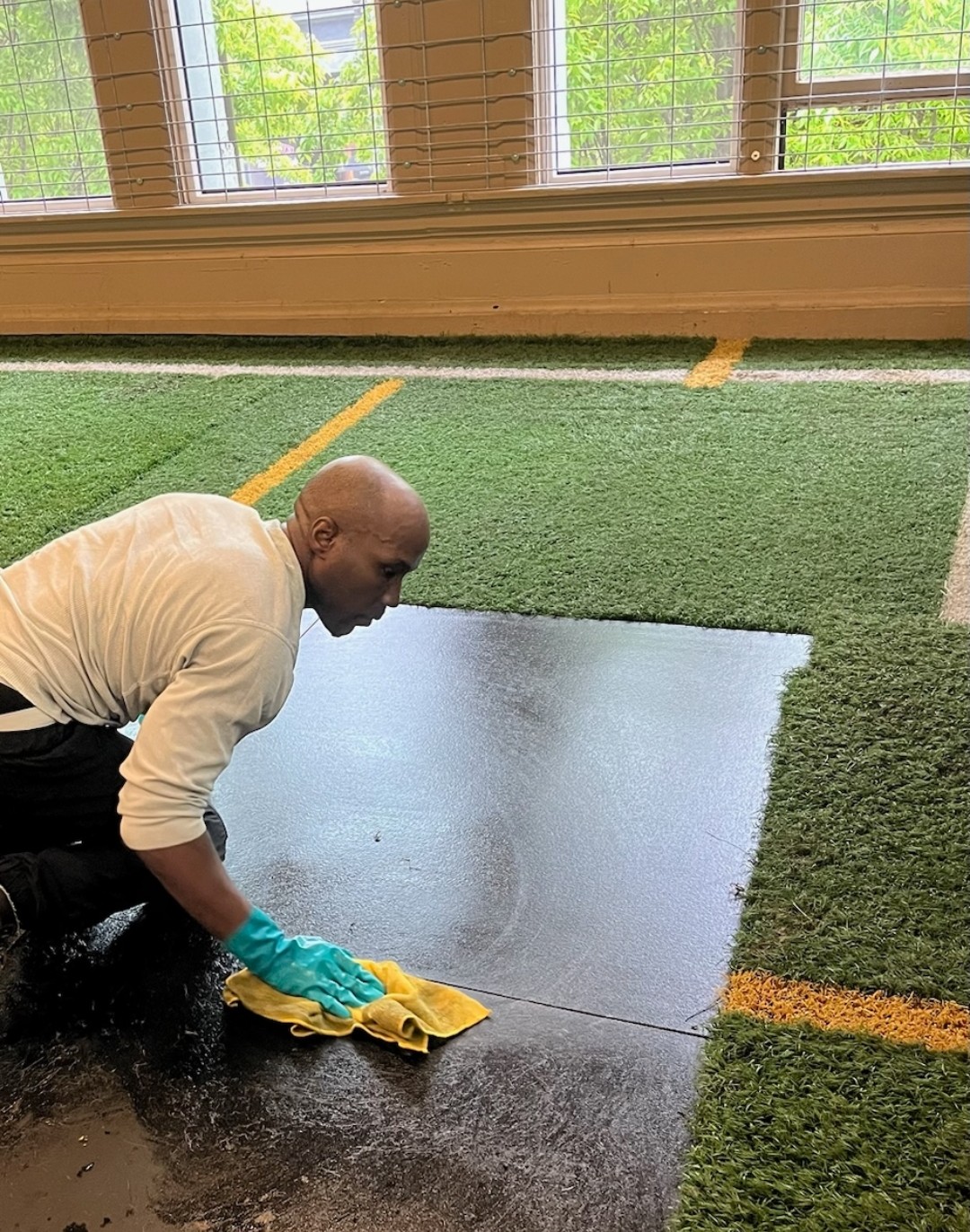 Nathan Ellis cleaning a floor